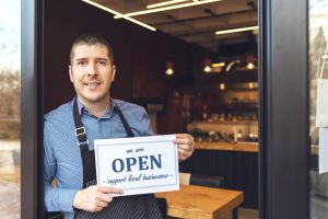 Small Business owner standing outside of store